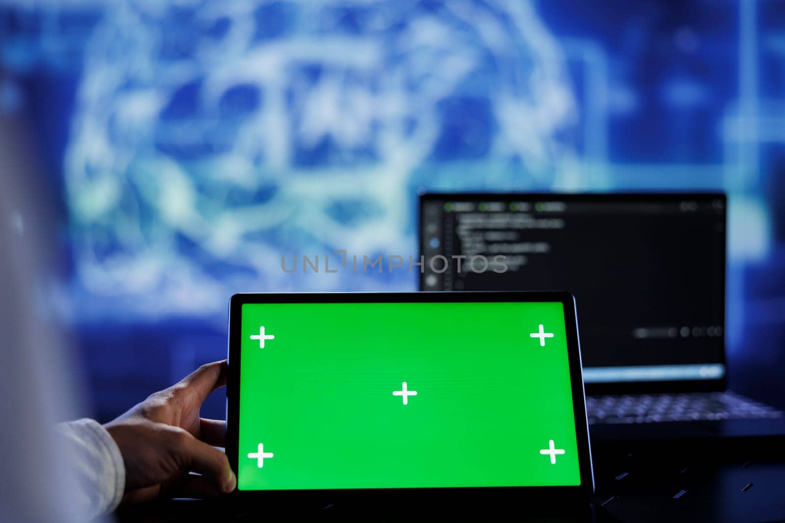 Admin writes code on green screen tablet to visualize artificial intelligence neural networks using augmented reality. High tech workspace supervisor runs AI script on chrome key device