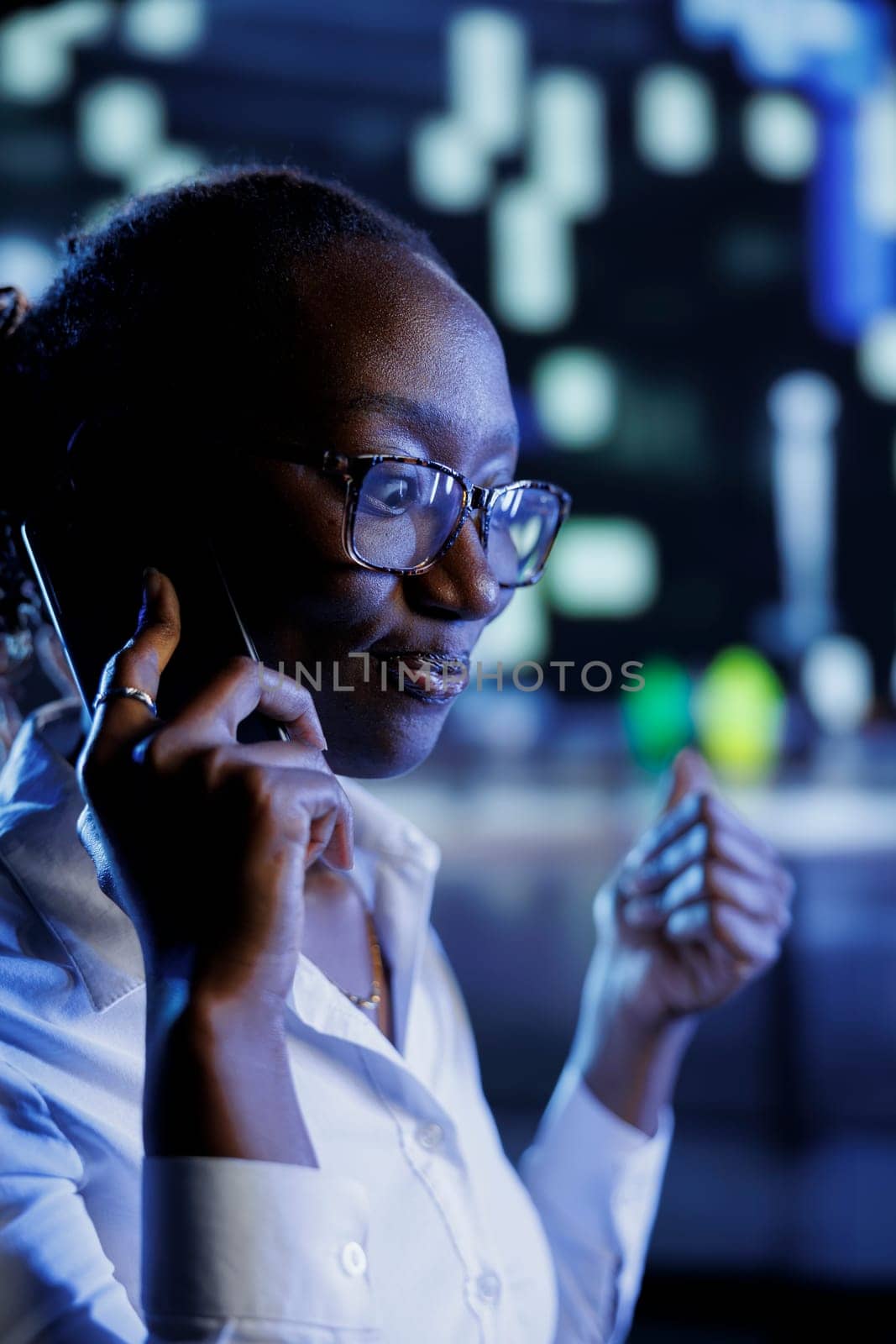 African american woman strolling around cityscape at night, enjoying conversation over the phone with best friend. Citizen walking home from work, making telephone calls to make commute more enjoyable