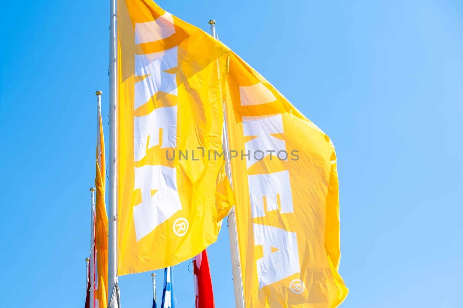 Yellow IKEA flags against blue sky by vladimka