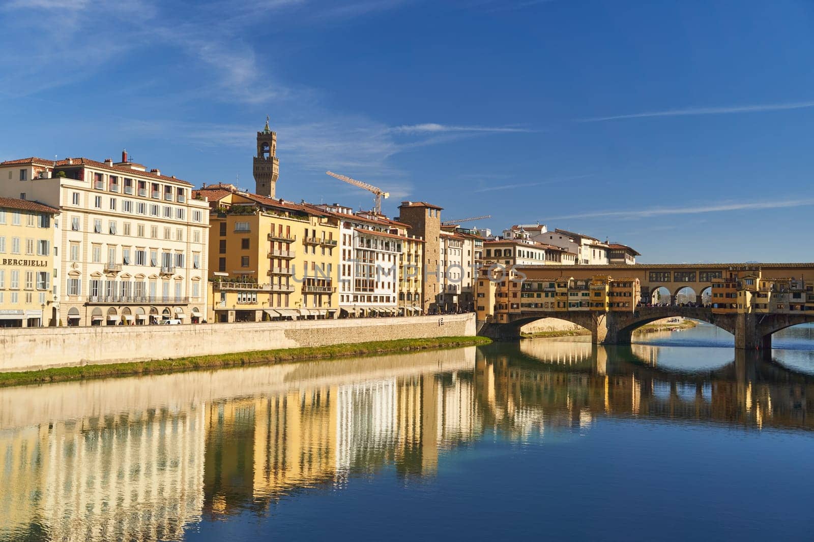 Florence, Italy - 12.02.2023: View of the famous Ponte alle Grazie bridge and the Arno river in Florence. High quality photo