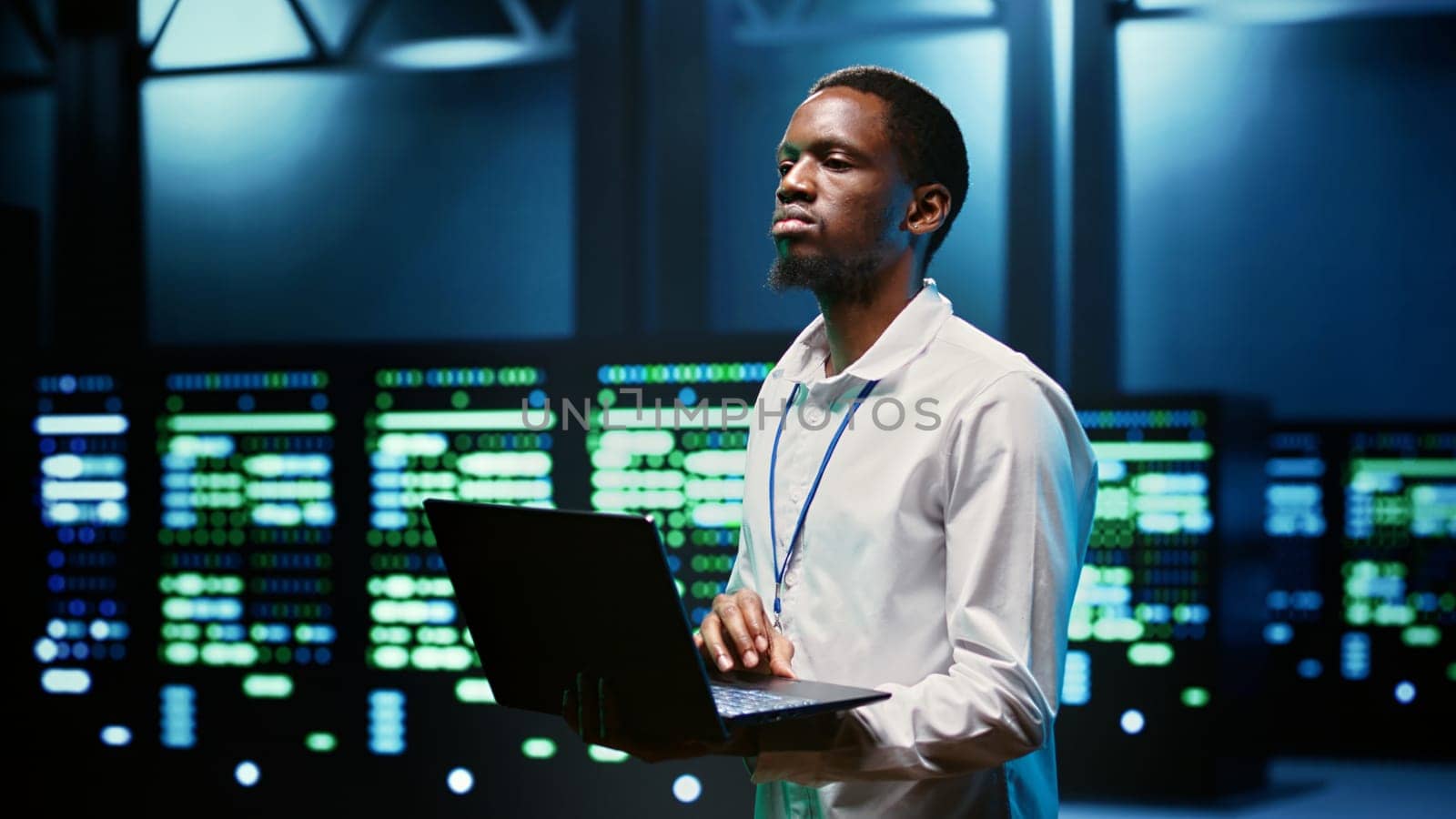 African american specialist in high tech establishment mending network problems affecting server clusters performance and connectivity, leading to slow data transfer rates