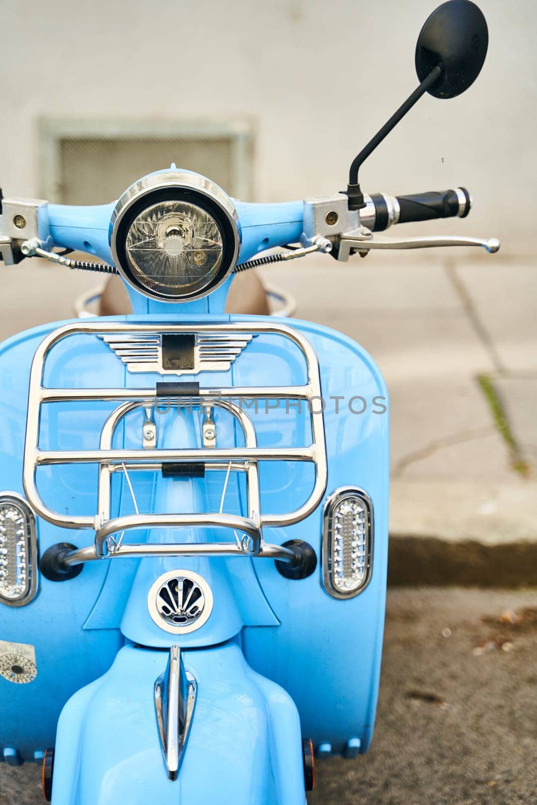 Blue scooter parked on roadside, motor vehicle with automotive design by driver-s
