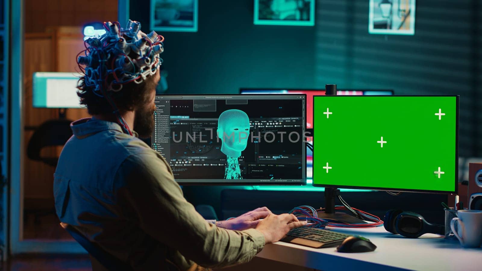 Developer using EEG headset, starting mind upload process using isolated screen desktop. Man using neuroscientific device to transfer consciousness into cyberspace with chroma key monitors, camera A