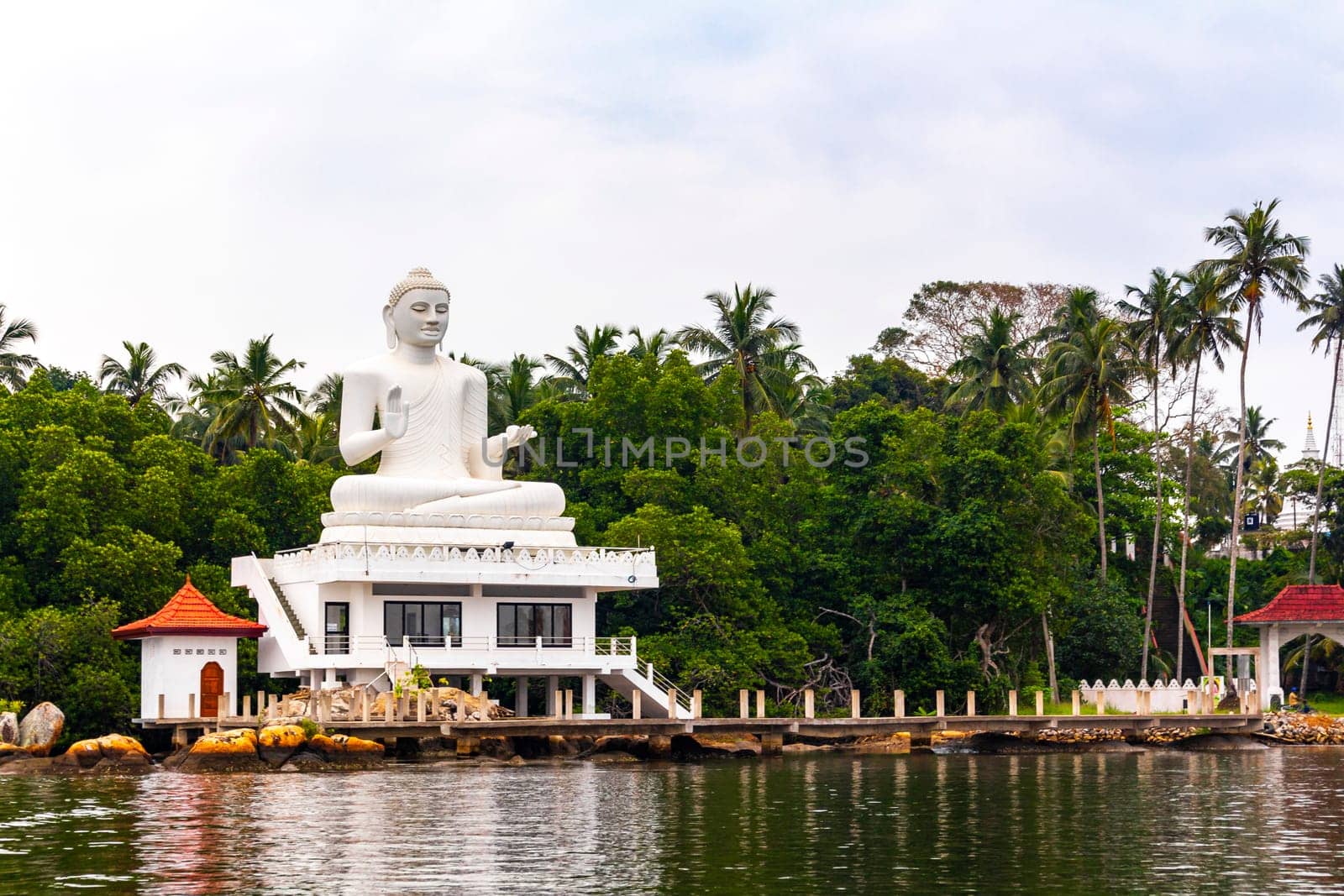 Large white Buddha statue in Bentota Udakotuwa Temple at Bentota Ganga in Bentota Beach Galle District Southern Province Sri Lanka.