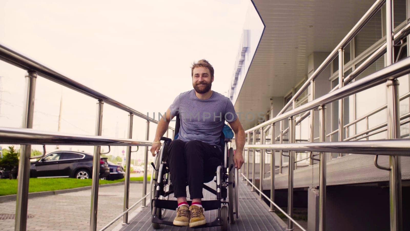 A disabled man in a wheelchair riding down the slope by Chudakov