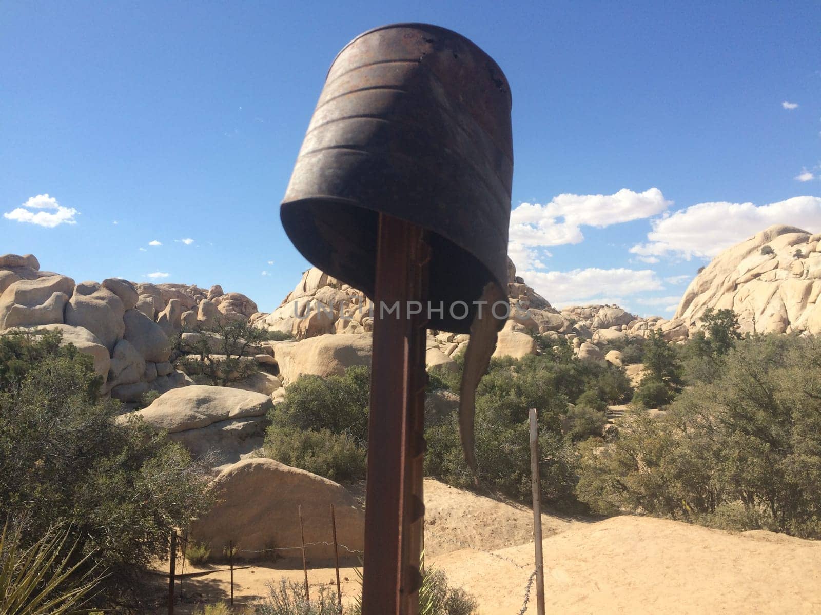Rusty Old Can Upside Down on Post in Scenic Desert . High quality photo