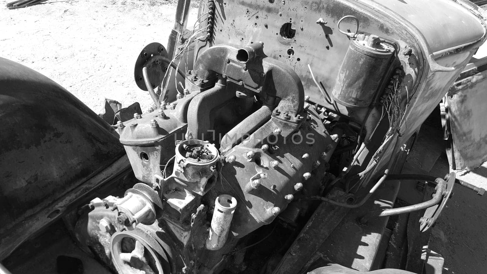 Black and White Engine Compartment of Old Vehicle Rusting in California Desert. High quality photo