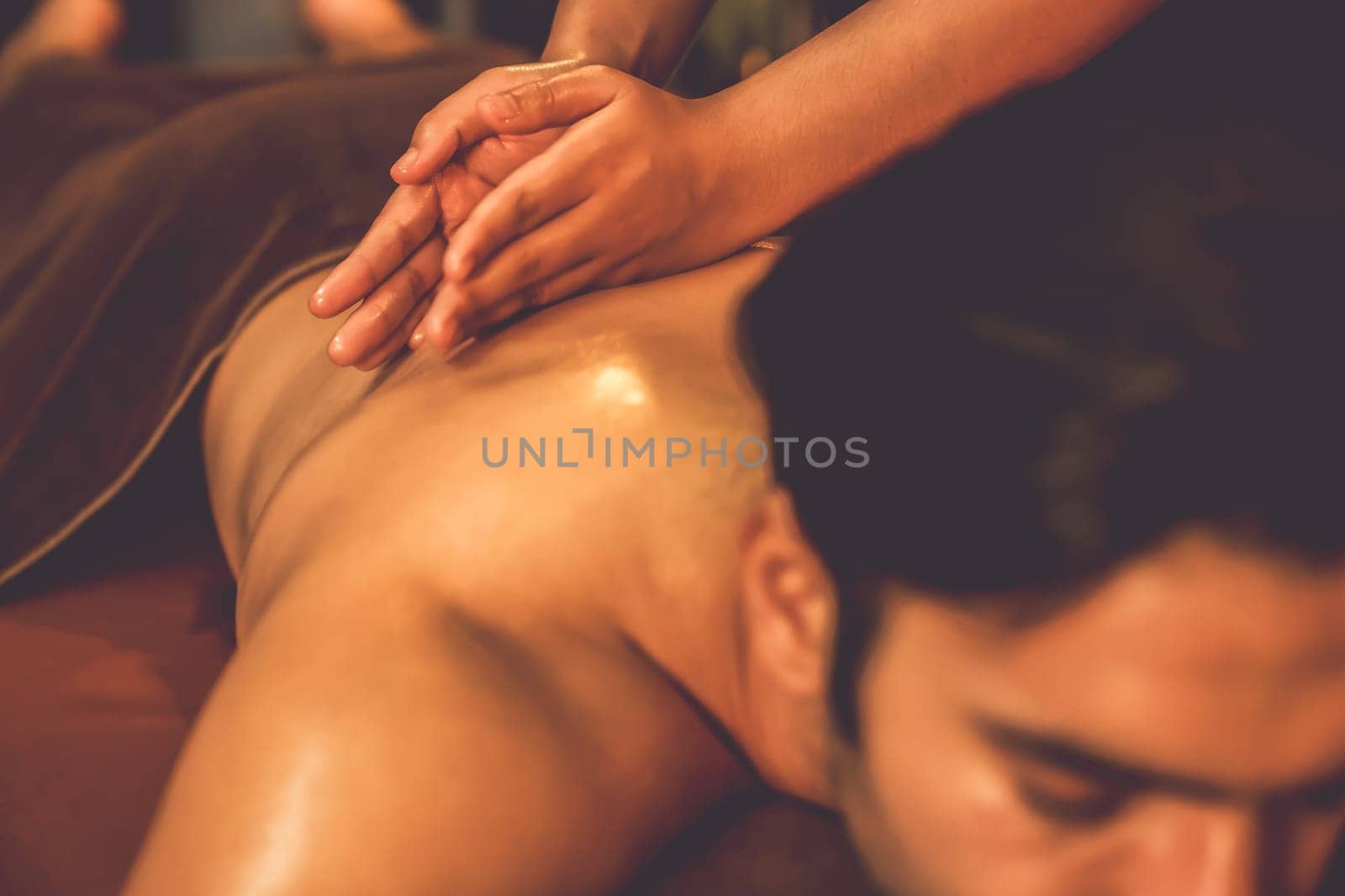 Caucasian man customer enjoying relaxing anti-stress massage. Quiescent by biancoblue