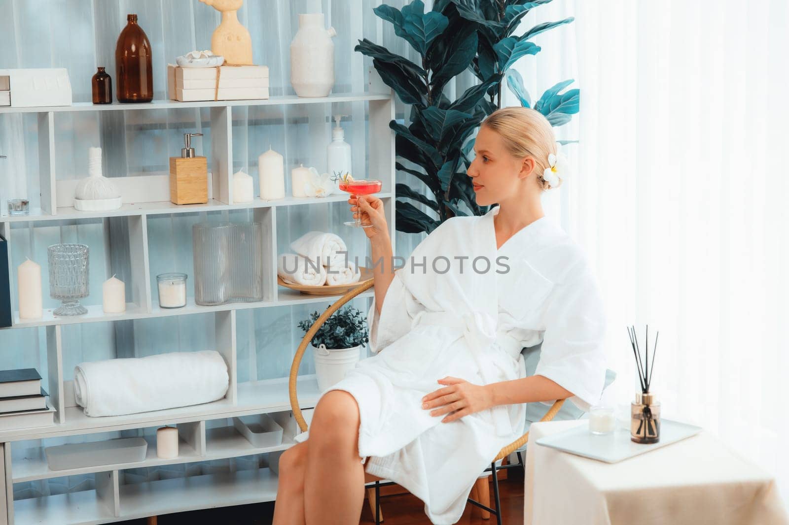 Couple wearing bathrobe relaxing with drinks in luxurious hotel spa. Quiescent by biancoblue
