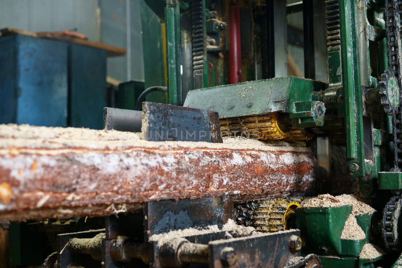At sawmill. Image of sawing log on machine, close-up