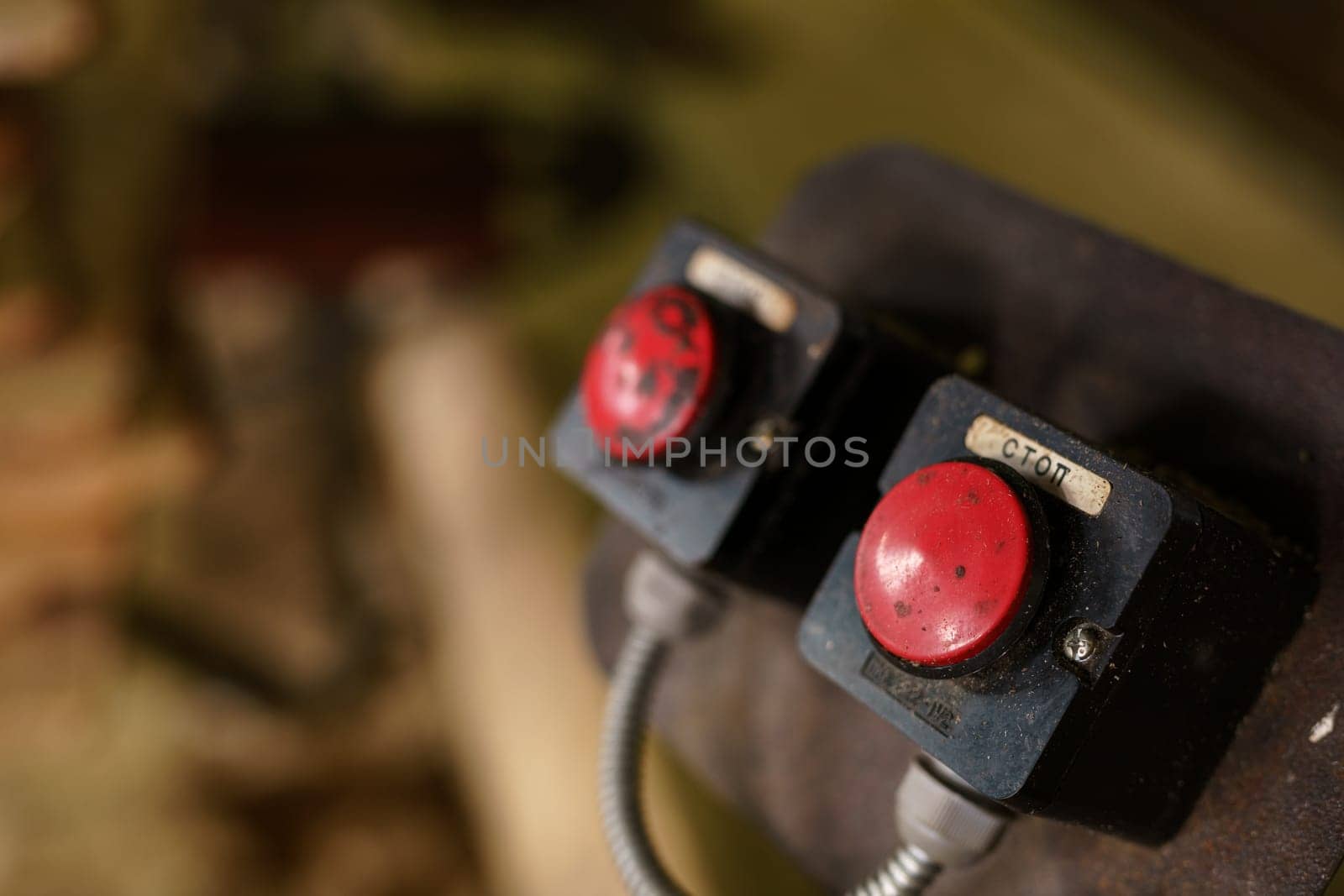 Machine control panel with two red buttons, close-up
