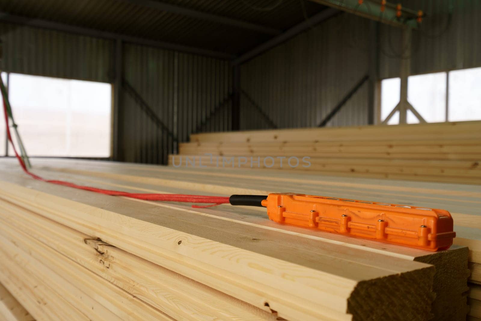 Remote control for crane is on wooden bar, close-up