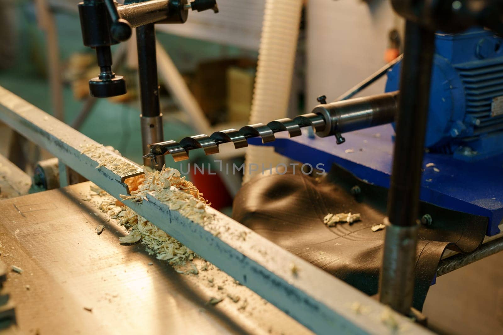 Woodworking. Image of drill machine and shavings, close-up