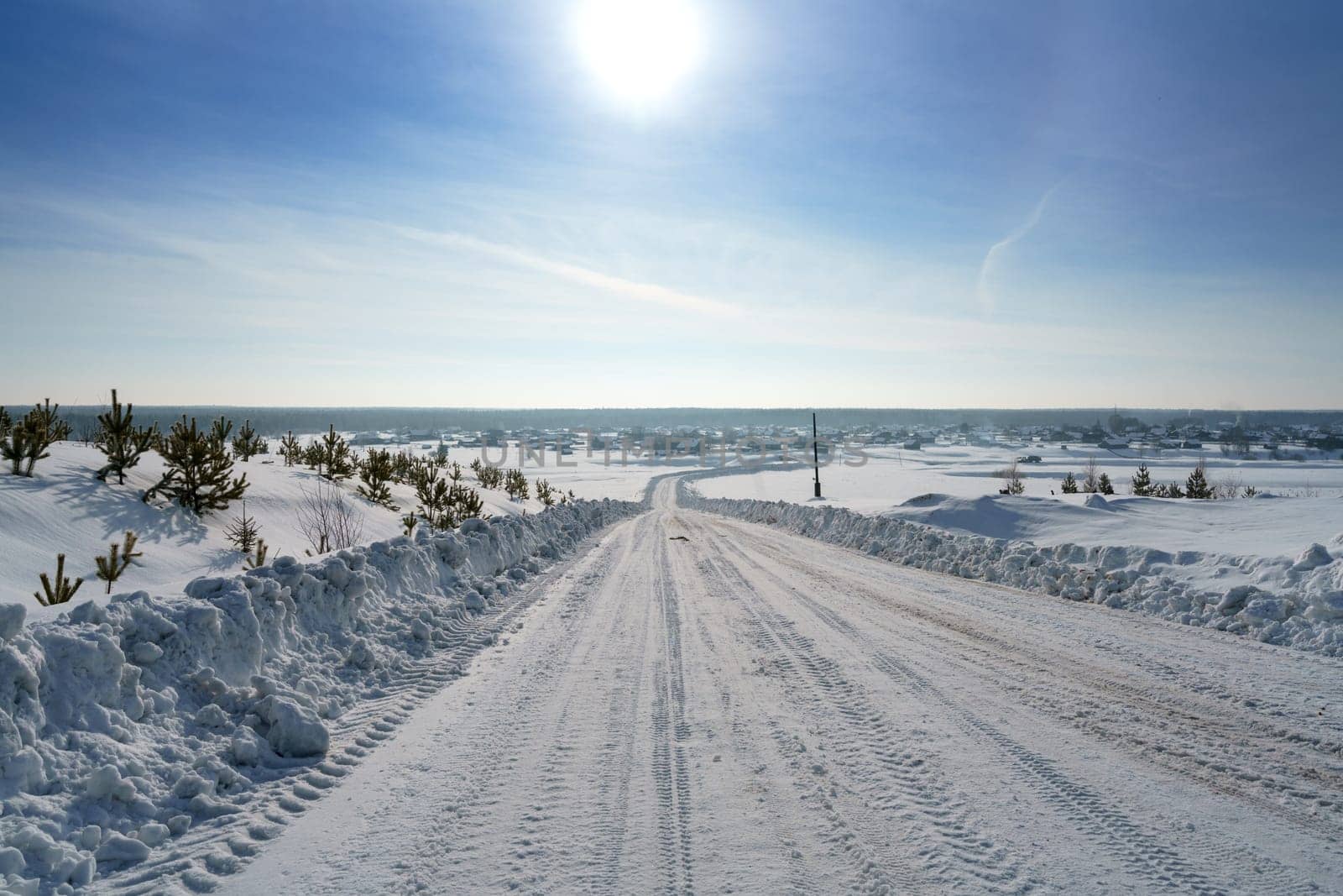 Countryside. Image of road to village in winter by rivertime