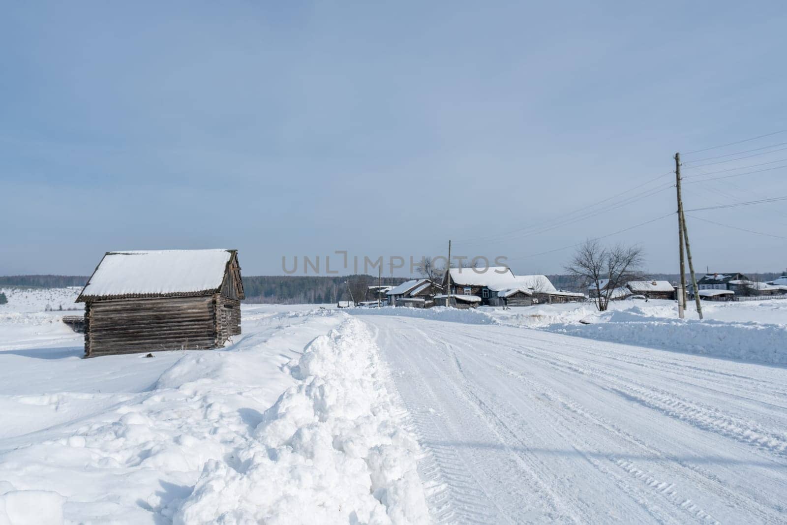 Image of Russian village in winter time by rivertime