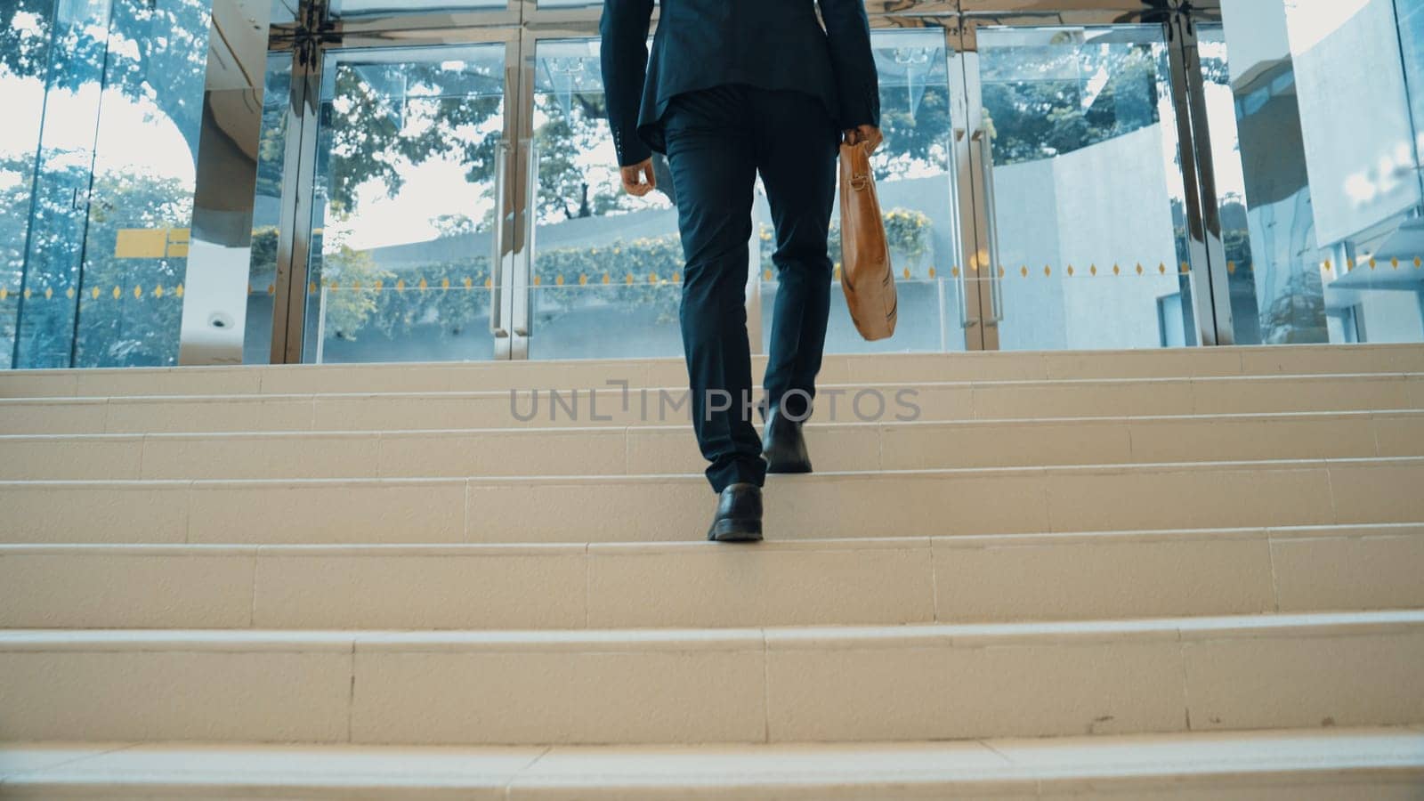Closeup of business man leg go up the stairs. Traveling. Back view. Exultant. by biancoblue