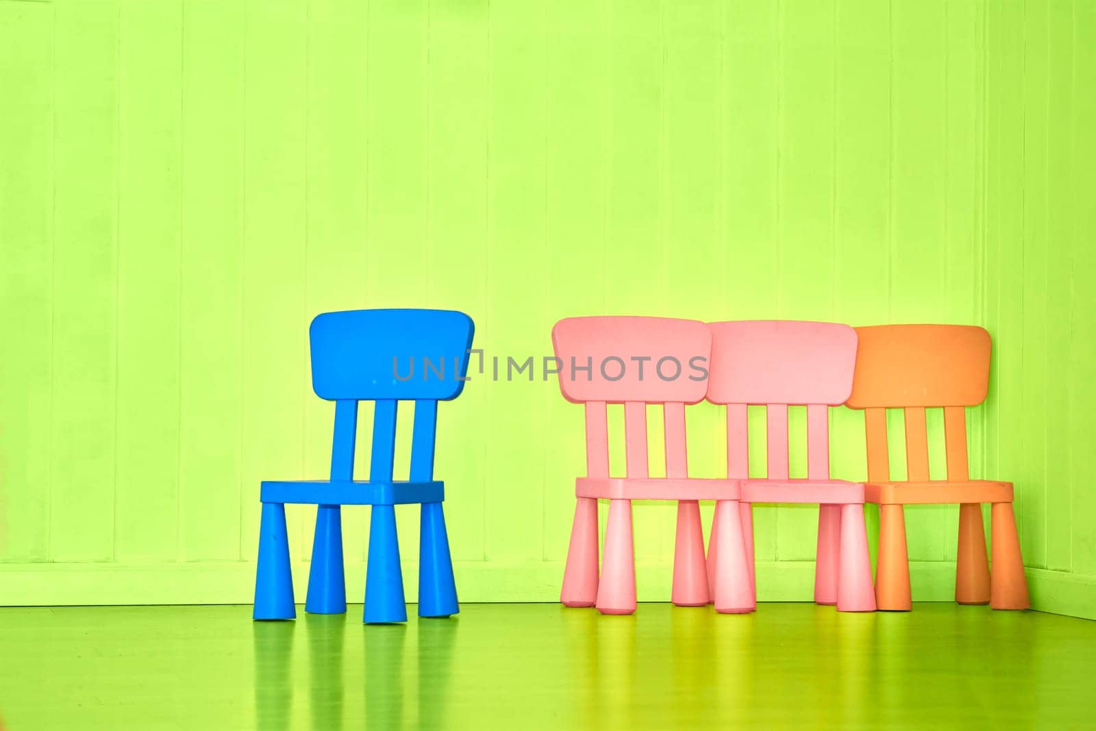 Playroom in kindergarten. Multi colored children's chairs by jovani68