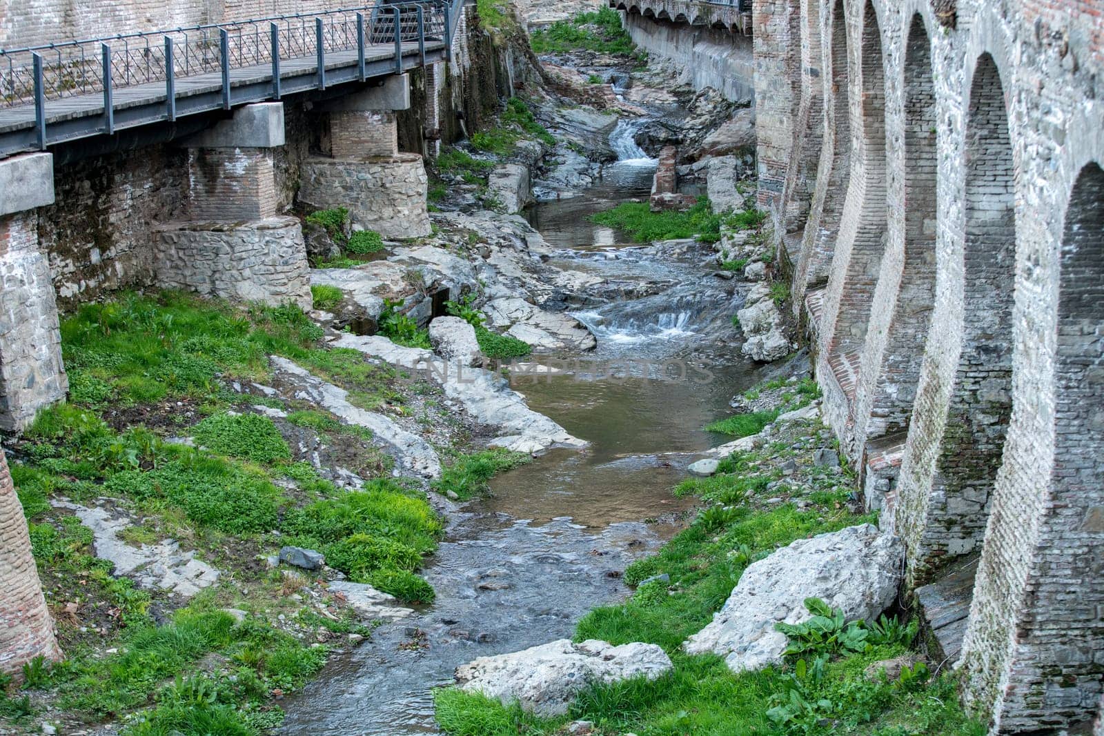 Creek flows between supports of fortress. Georgia by rivertime