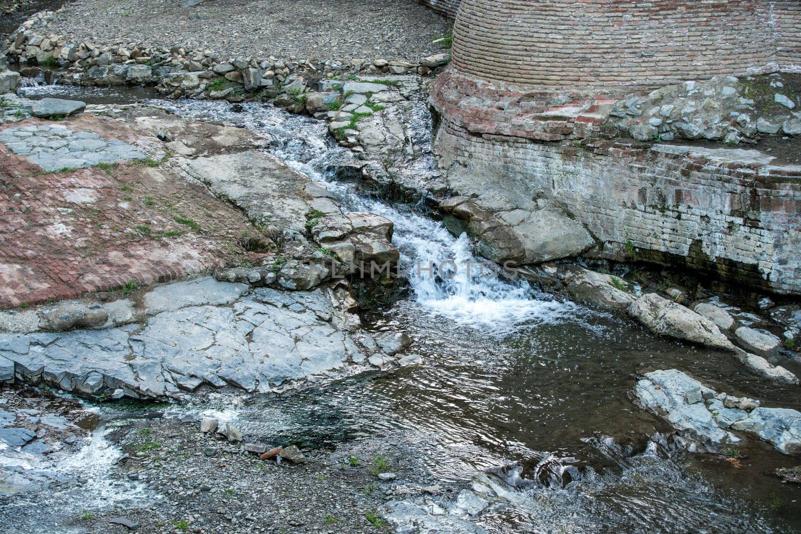 Image of creek between stones, close-up. Tbilisi, Georgia