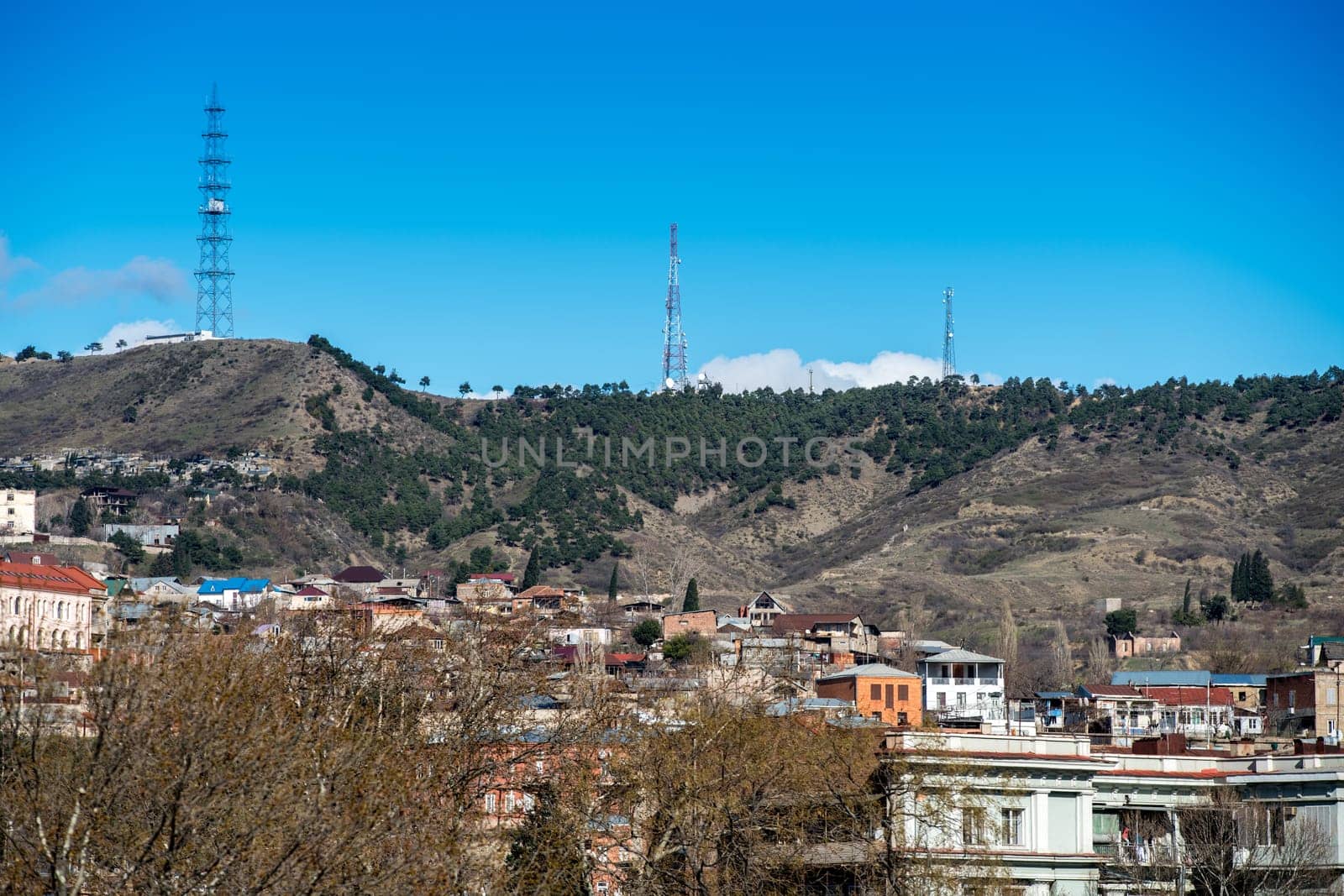 Cityscape. On hills located cell towers. Georgia by rivertime