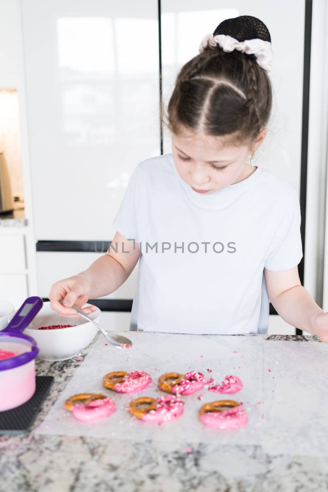 Young Chef Prepares Chocolate-Covered Treats in Sunny Kitchen by arinahabich