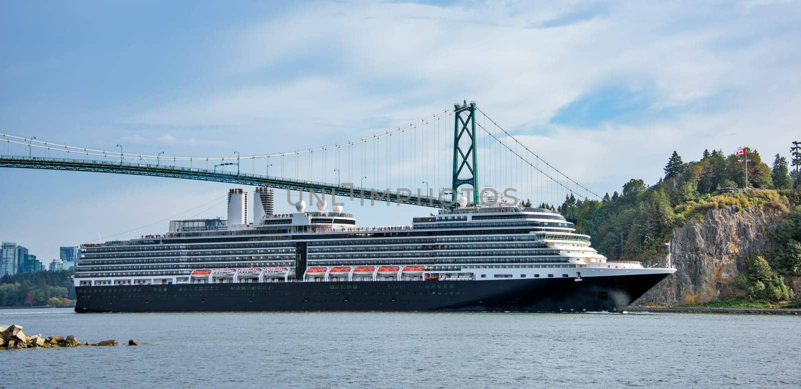 Open sea cruise ship passing under famous Lion Gates Bridge in Vancouver, Canada.