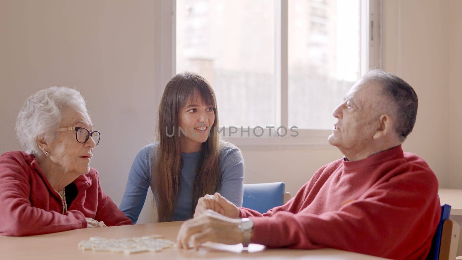 A grandfather talking with the family during a visit in a geriatric