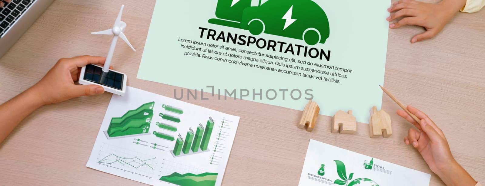 Electric vehicle poster placed on meeting table at green business meeting. ESG environment social governance and Eco conservative concept. Closeup. Delineation. Top view. Delineation.