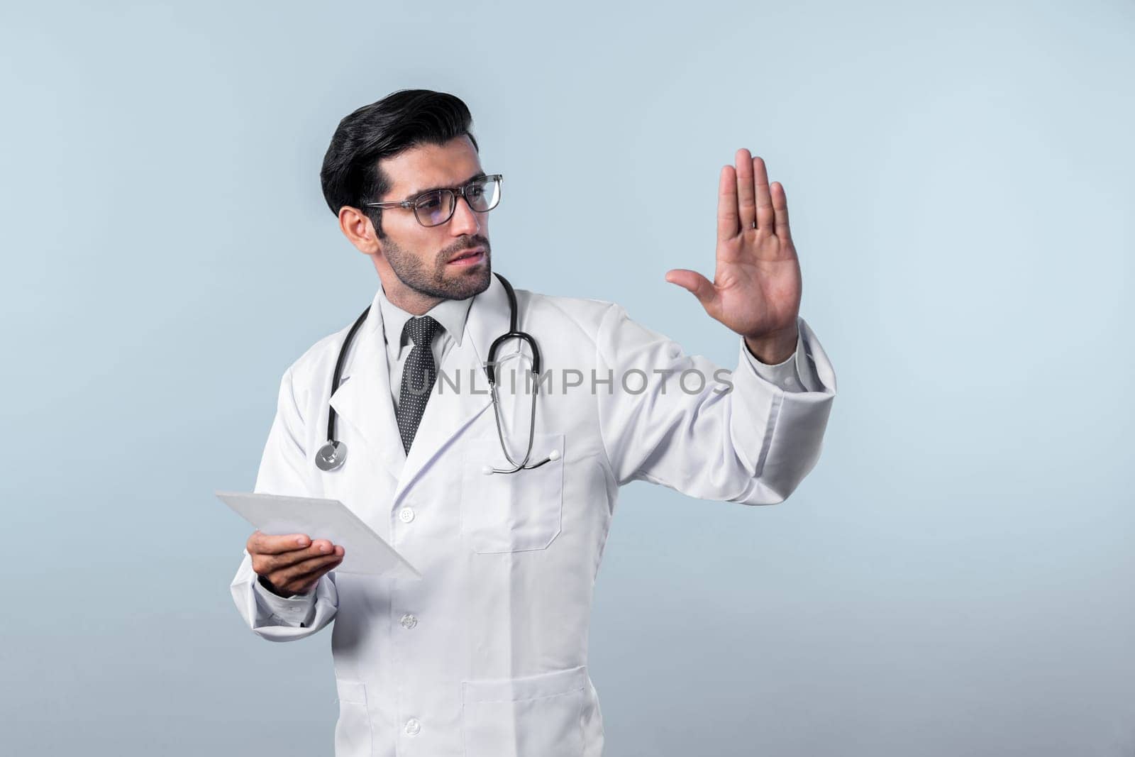 Caucasian smart doctor pointing while standing and wearing lab coat. Deviation. by biancoblue
