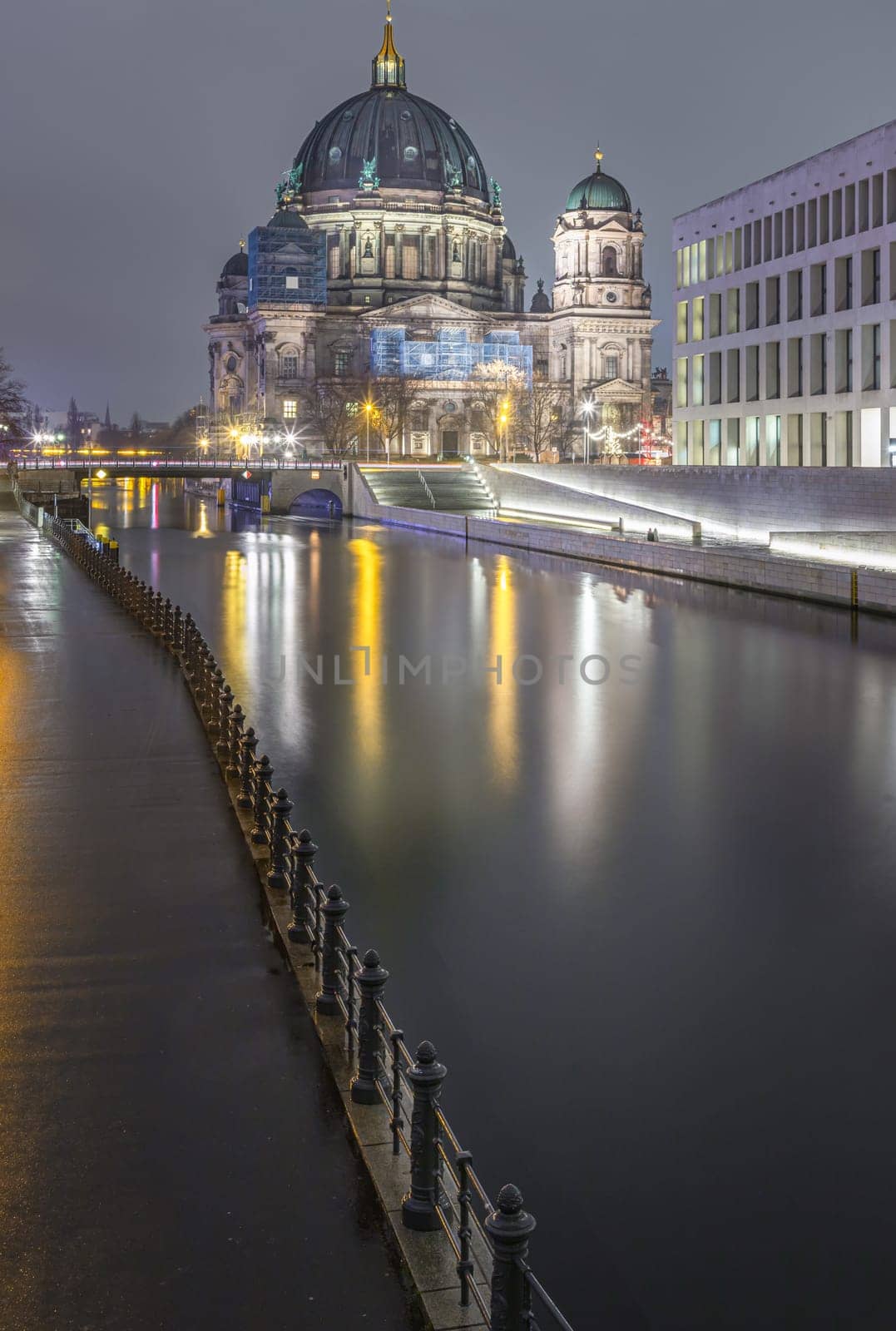 Berlin, Germany - Dec 19, 2023 - Picturesque view of The historic berlin cathedral building with a bridge over the river Spree at dusk. Berlin Cathedral Berliner Dom in Berlin, Space for text, Selective focus.
