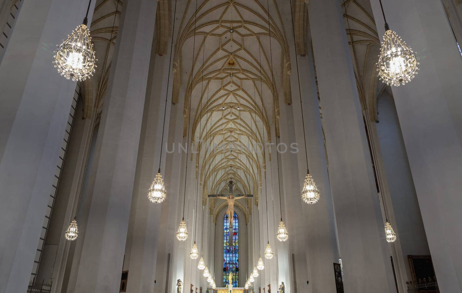 Munich, Germany - Dec 21, 2023 - Architecture interior of Frauenkirche or Cathedral Church of Our Lady, Jesus hanging on the cross in the interior of Frauenkirche, The structure is the most iconic building of Munich. Space for text, Selective focus.