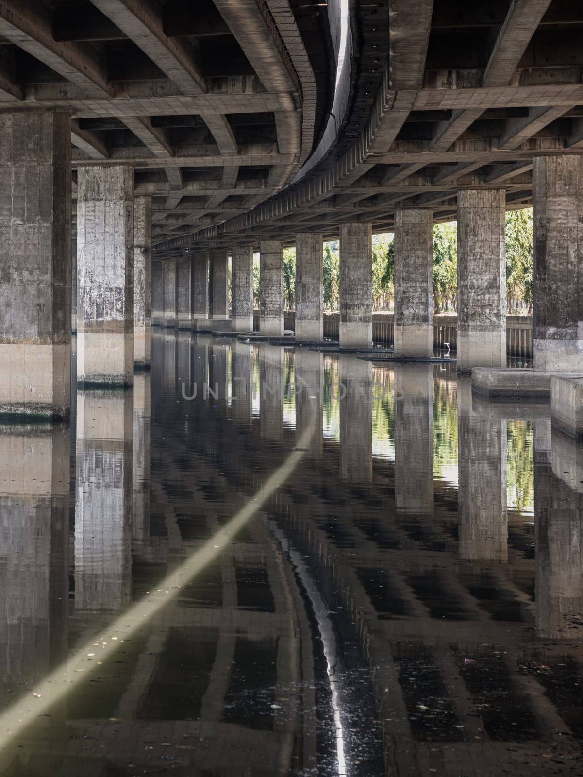 Perspective view of concrete pillars under Khlong Toei Expressway. by tosirikul