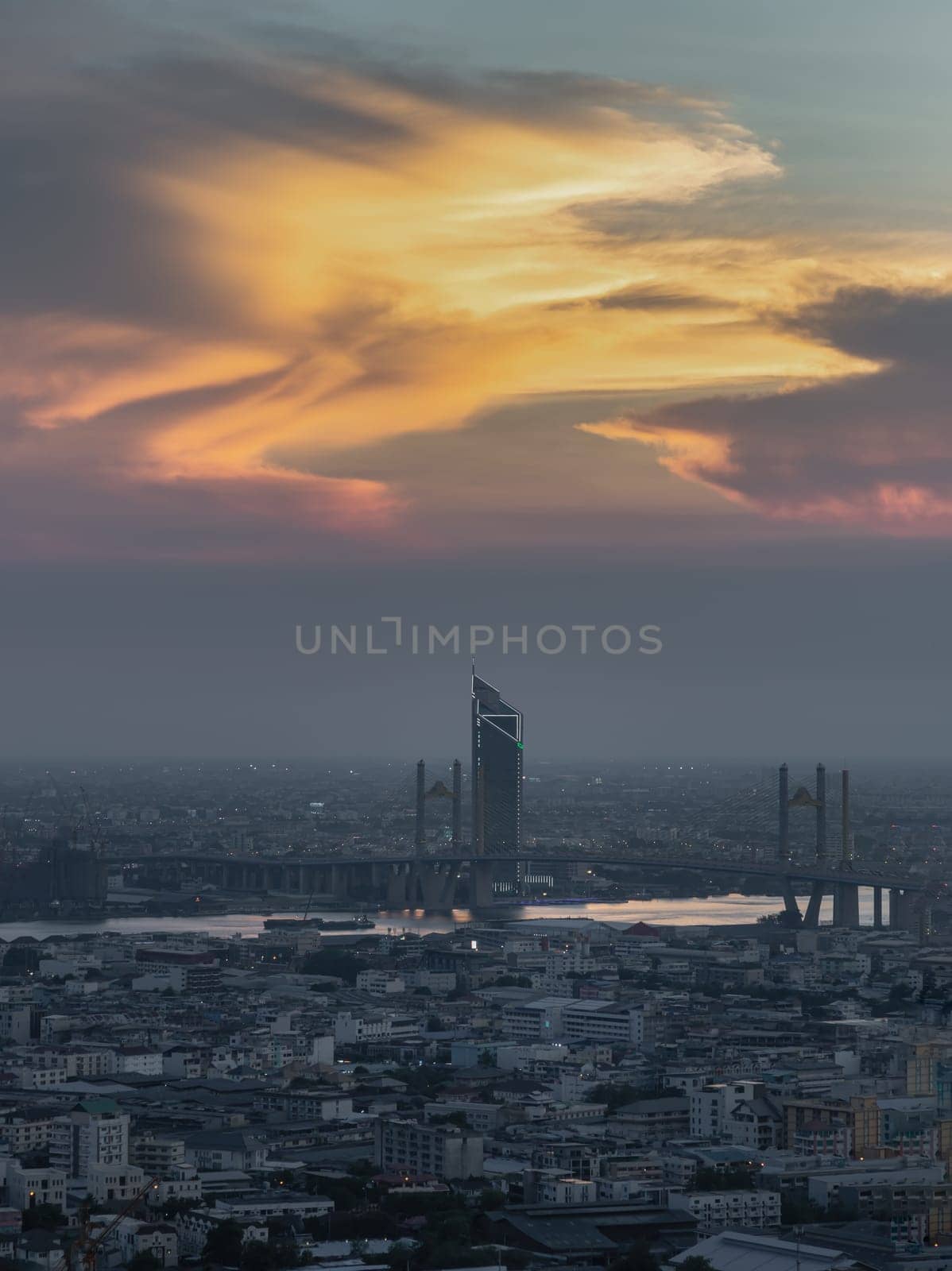 Gorgeous view of sunset on the sky over large metropolitan city in Bangkok. by tosirikul