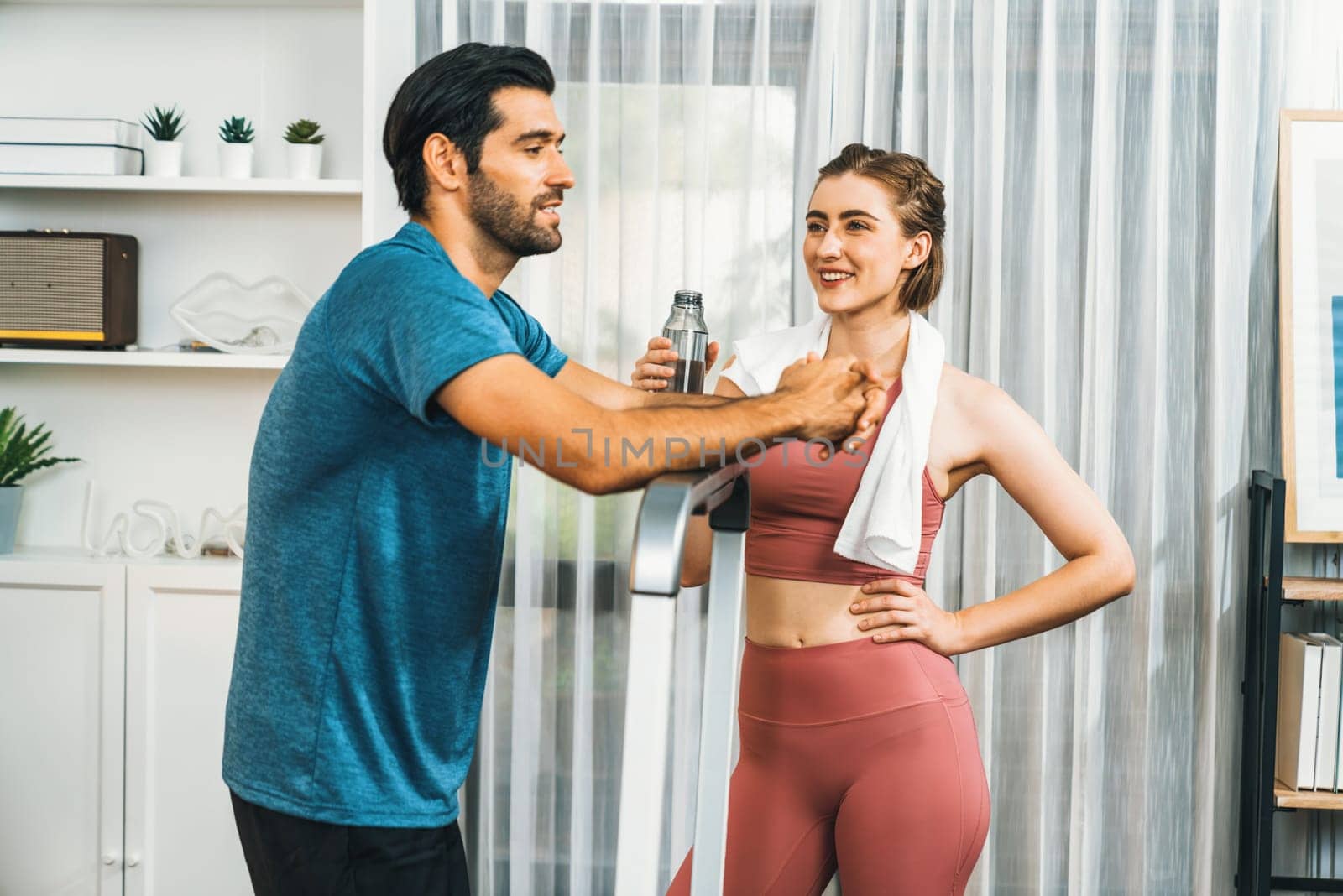 Athletic body and sporty young couple or workout buddy in sportswear warmup or resting after finishing in home workout exercise at gaiety home exercise and healthy lifestyle concept.