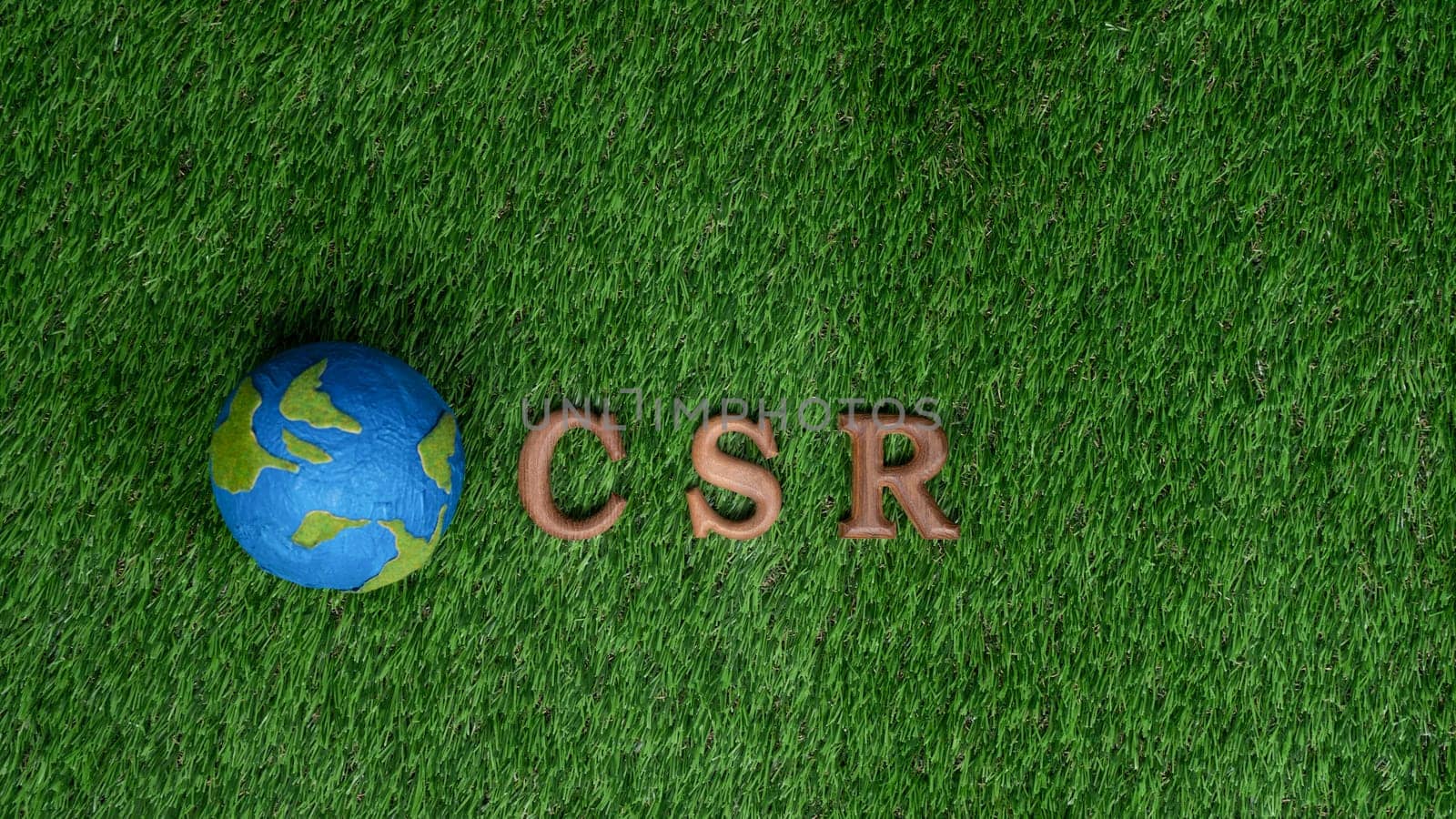 Arranged wooden alphabet text in CSR on biophilic background with Earth planet sign as eco symbol for corporate social responsible with net zero and environmental campaign for greener community. Gyre