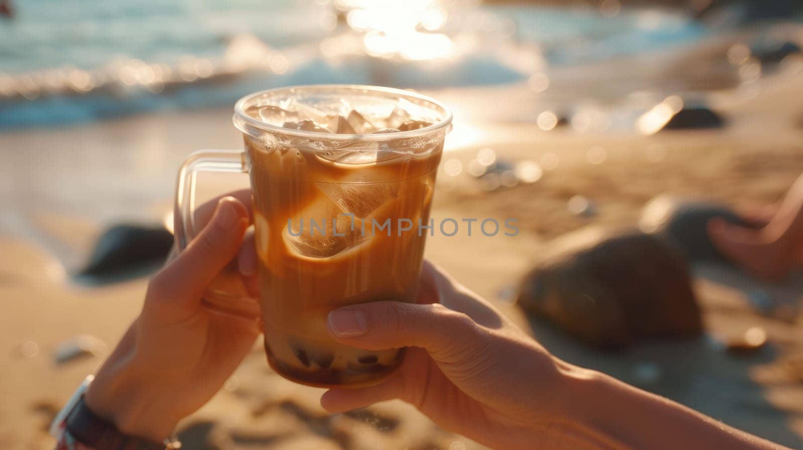 The close up picture of the person is holding the cup of the coffee by their own hand also walking at the side of the beach near the sea or an ocean that has been shine by the light from a sun. AIG43.