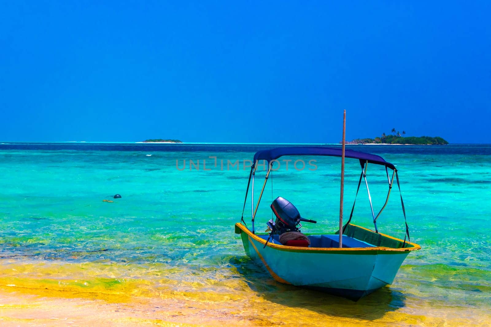 Motor engine of a speedboat in the blue turquoise water on Rasdhoo island in Rasdhoo Atoll Maldives.