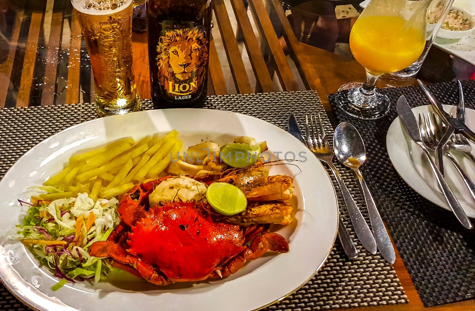 Lobster Shrimps Crabs Squid Seafood on plate in the hand in Bentota Beach Galle District Southern Province Sri Lanka.