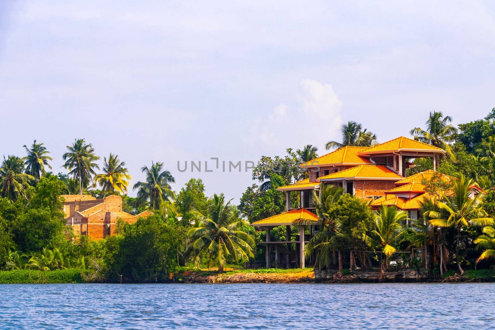 Boat safari trip jetty house boats through mangrove jungle forest in Bentota Ganga River Lake in Bentota Beach Galle District Southern Province Sri Lanka.