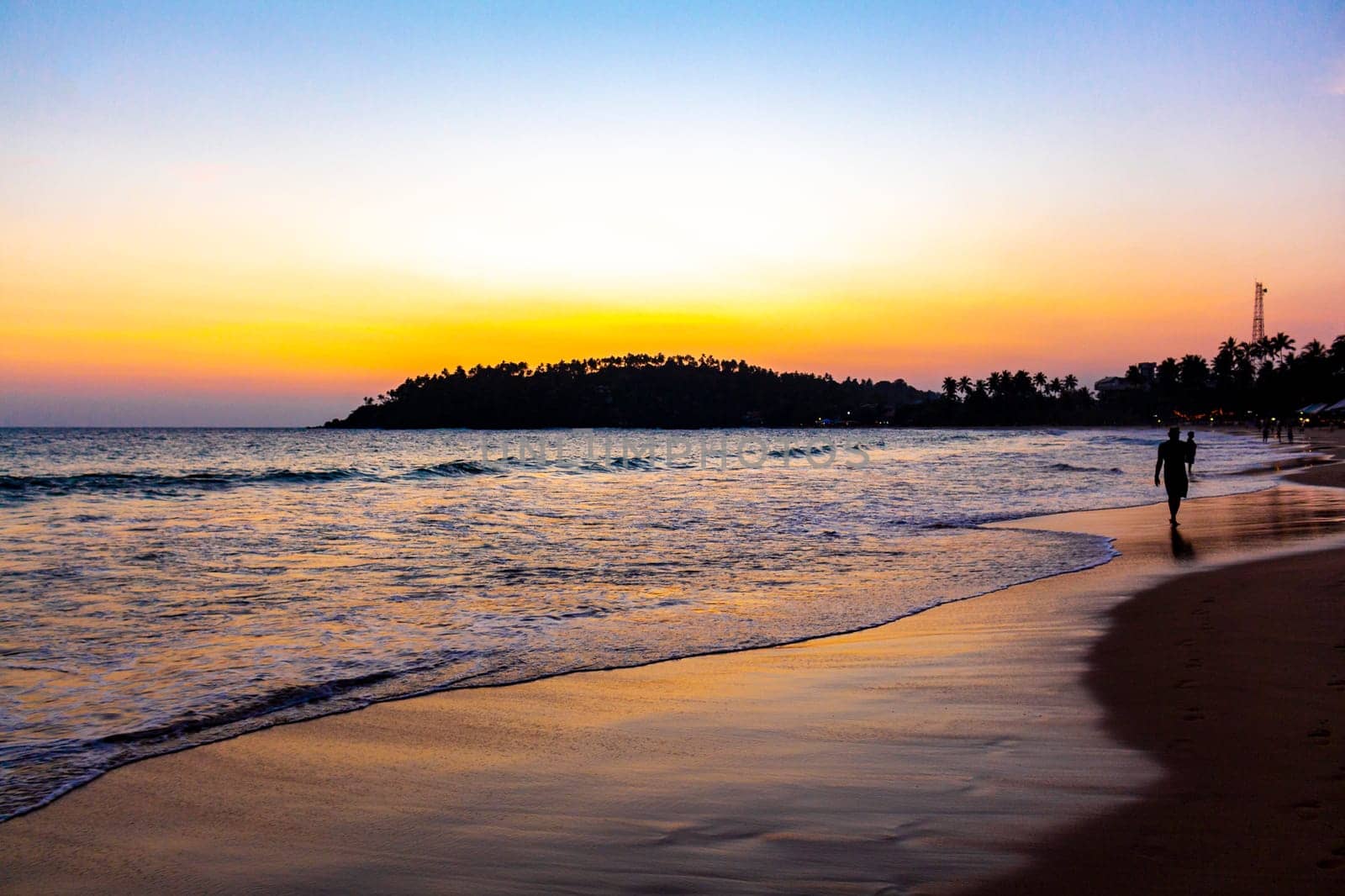 Beautiful paradise tropical beach waves sunset Mirissa Beach Sri Lanka. by Arkadij