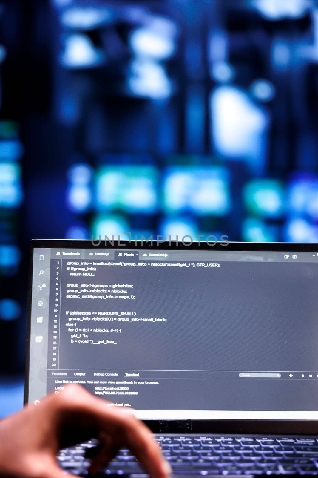 Computer scientists updating rackmounts, writing lines of code on laptop terminal, close up. Employees using JavaScript, Java, and database programming to ensure seamless server farm computing