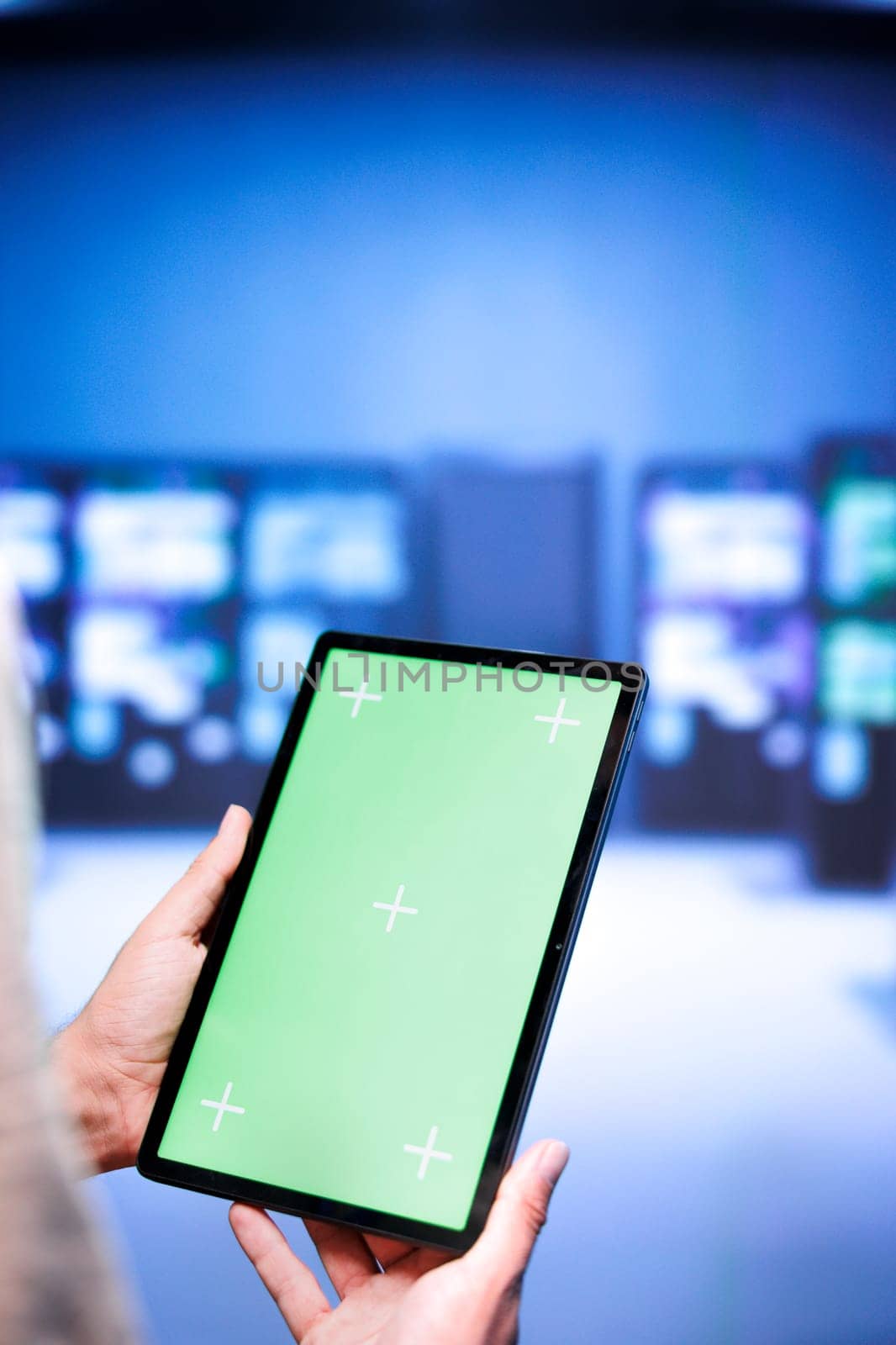 Technical support employee troubleshooting data center servers performance trends. Expert using chroma key tablet to spot high tech facility operational issues causing hardware to slow down