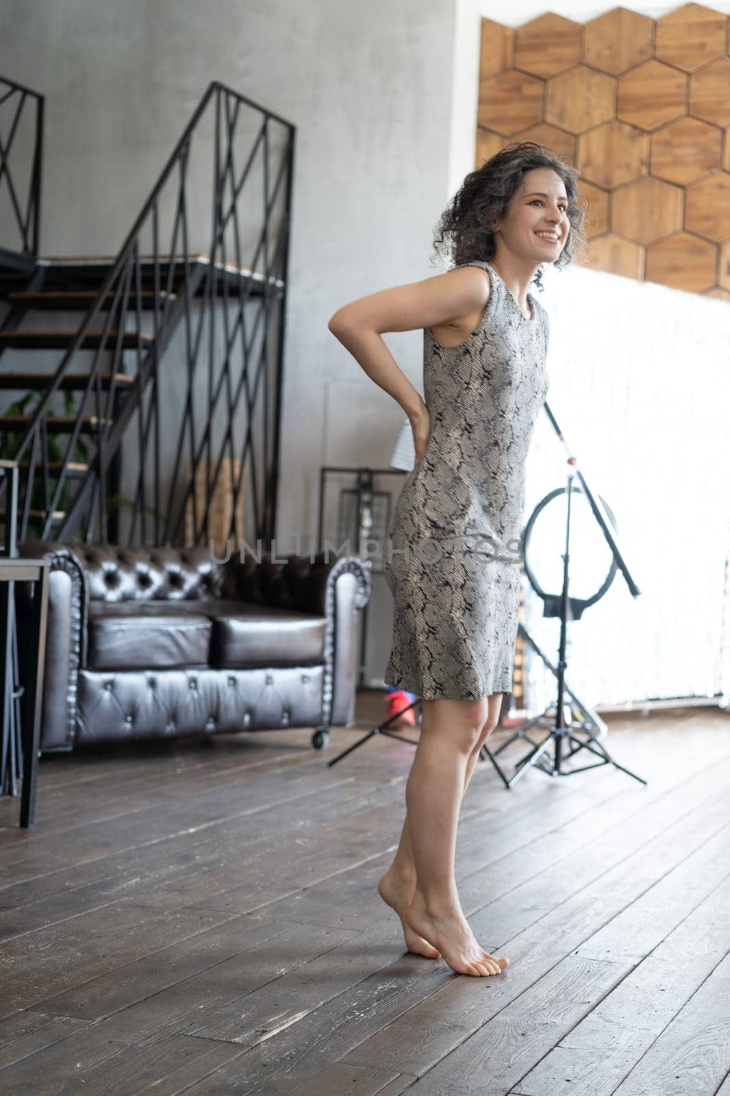 young beautiful woman posing in a short dress in the studio