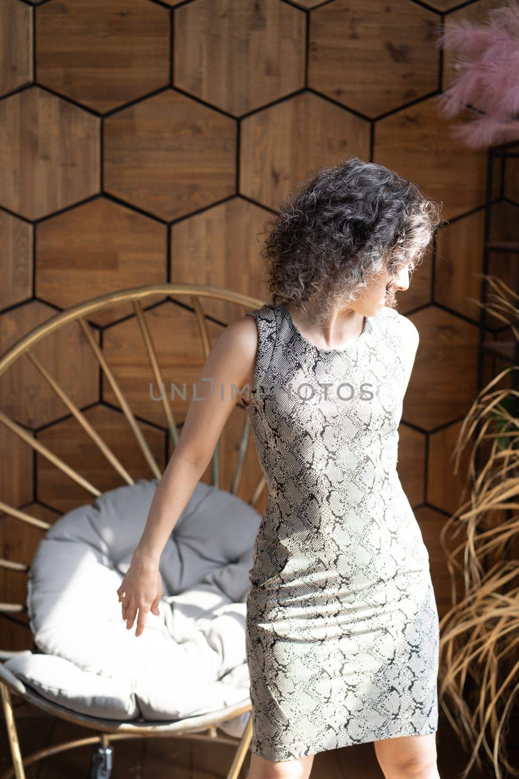 young beautiful woman posing in a short dress in the studio