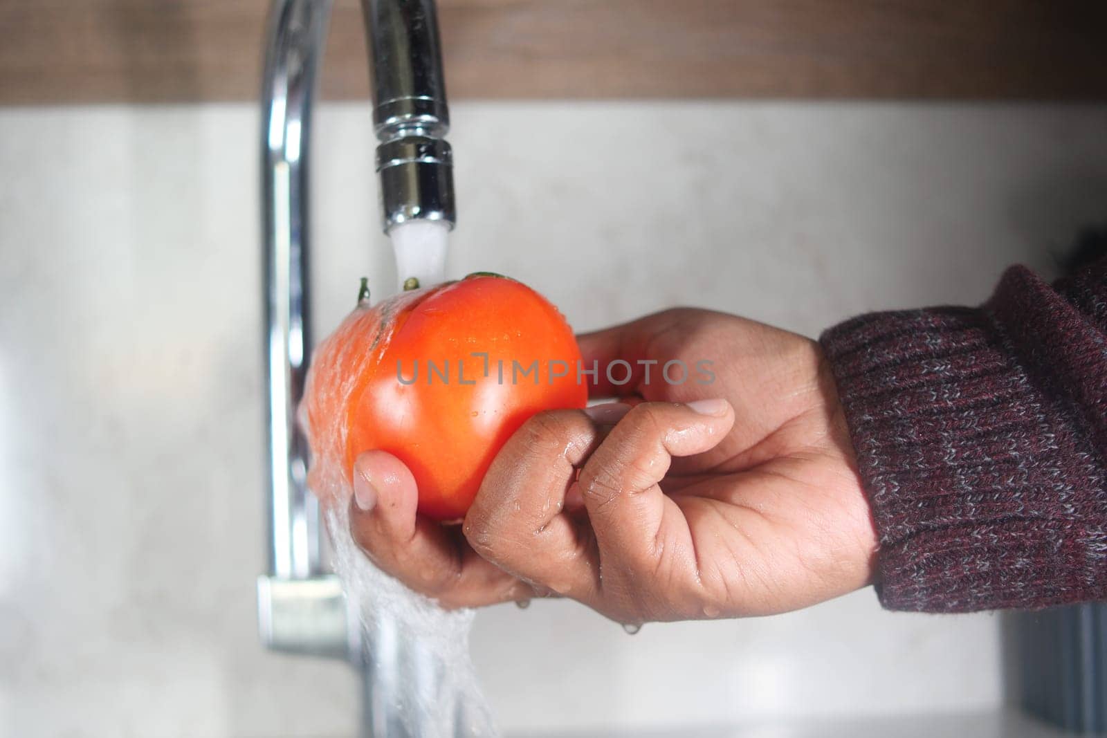 washing tomato with water sprinkling.