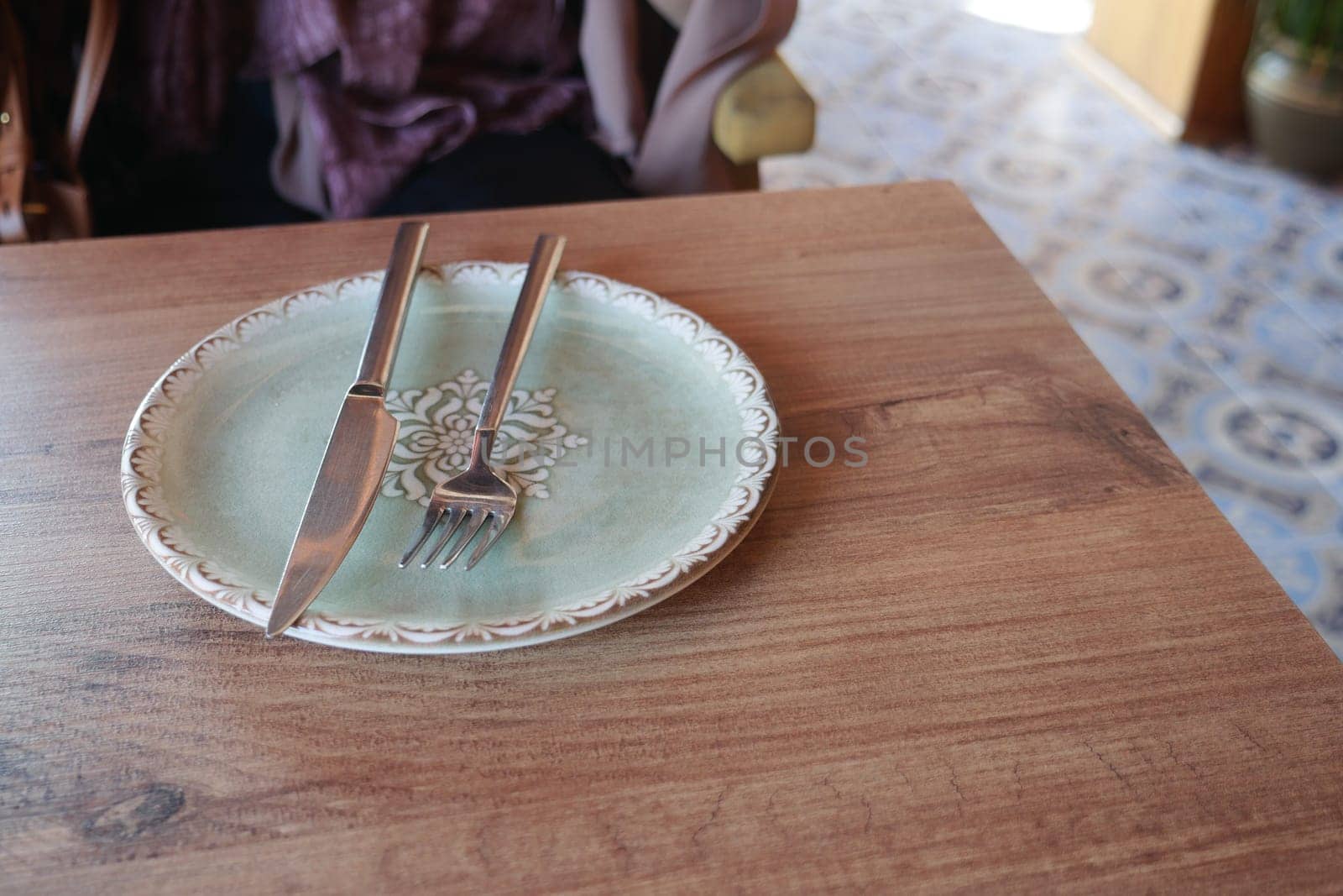 fork, knife and a circle shape plate on table .