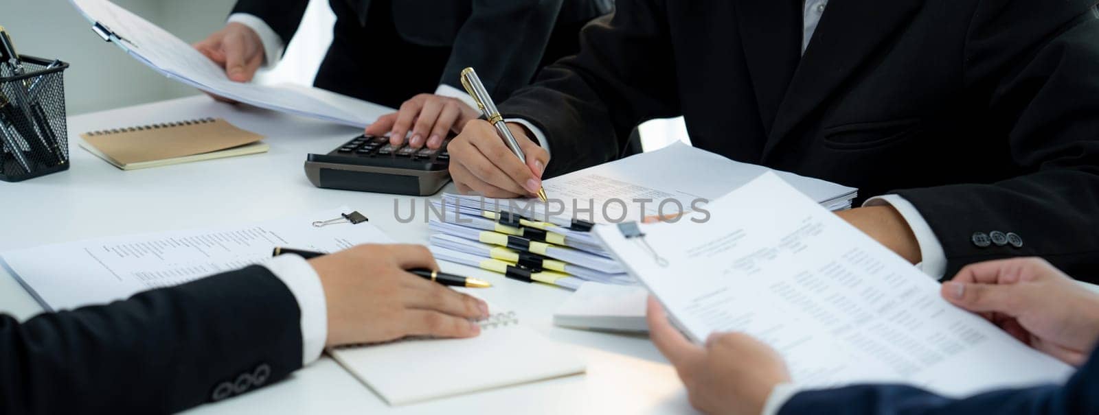 Corporate accountant team use calculator to calculate financial report. Shrewd by biancoblue