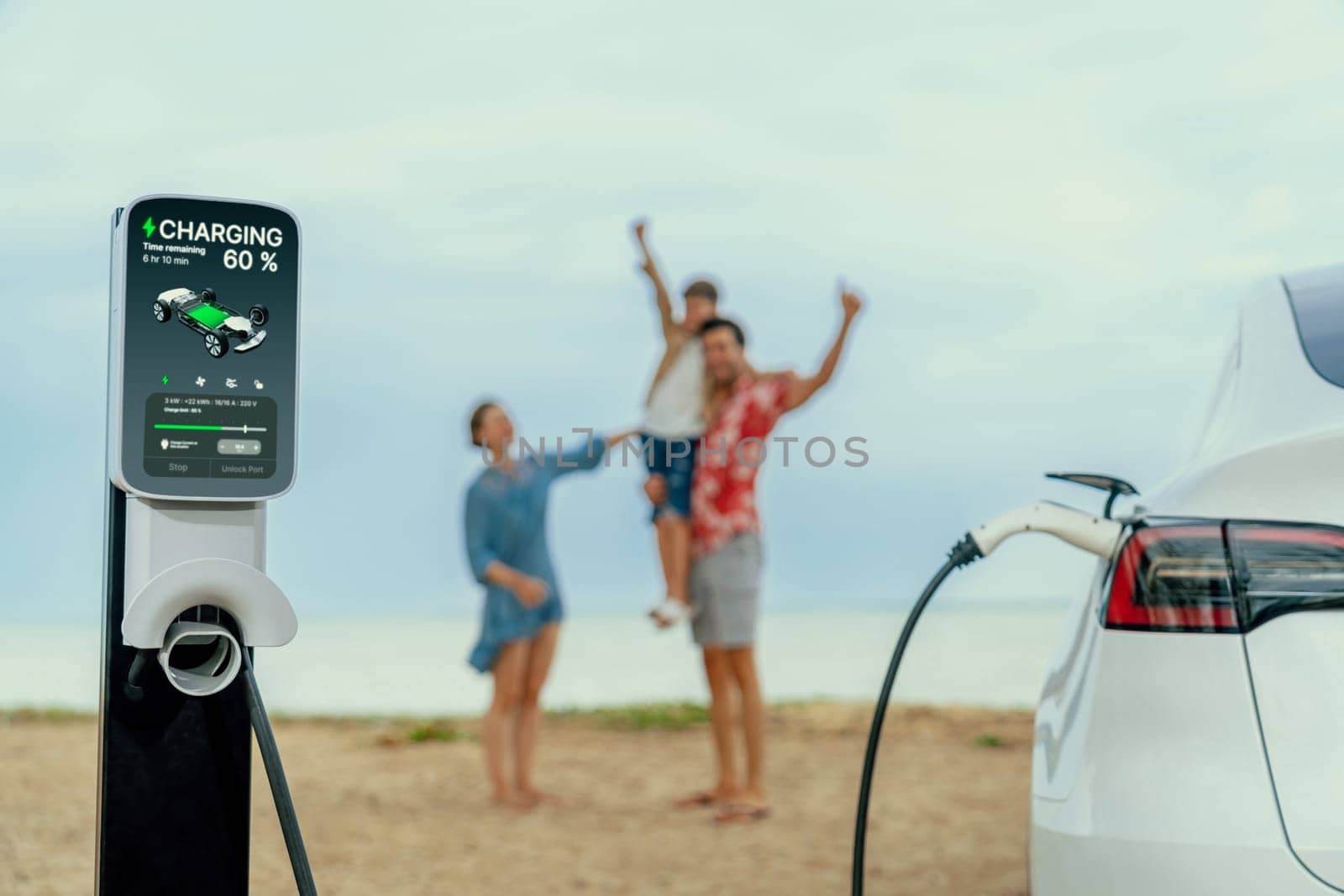 Alternative family vacation trip traveling by the beach with electric car recharging battery from EV charging station with blurred cheerful and happy family enjoying the seascape background. Perpetual