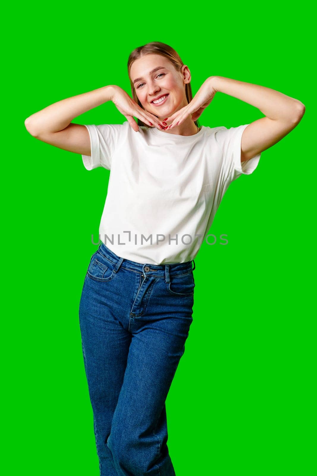 Young Woman Poses for Picture against green background in studio