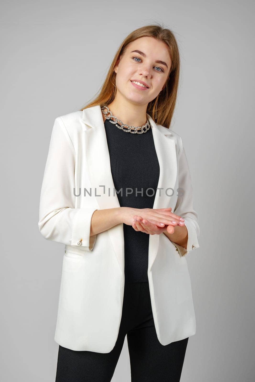 Woman in Black Top and White Jacket Posing in Studio by Fabrikasimf